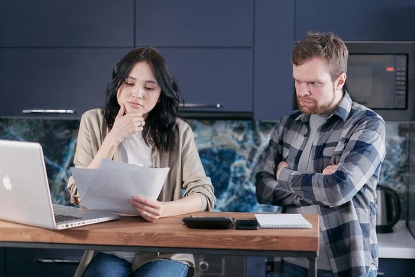 Man in athletic wear reviewing a training plan on a tablet in a calm setting.
